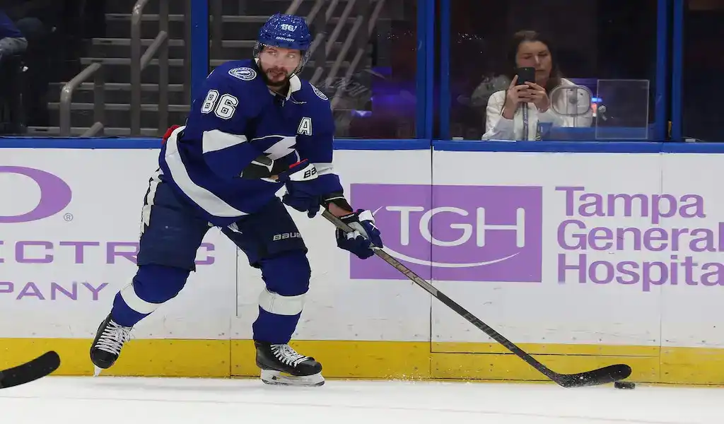 Tampa Bay Lightning player skating with the puck against the Pittsburgh Penguins during an NHL game on December 6, 2023.