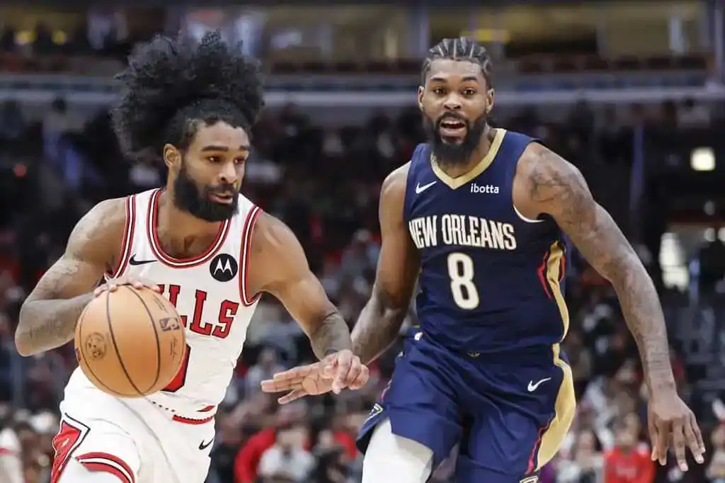 Chicago Bulls guard drives past a New Orleans Pelicans defender in a fast-paced NBA matchup.