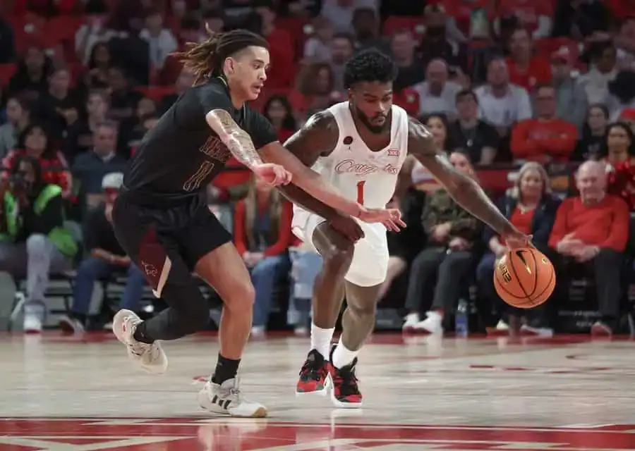 Two college basketball players in action
