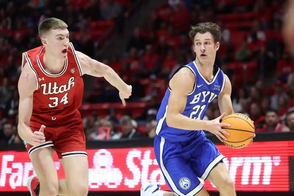 NCAAB 5 A BYU basketball player drives toward the basket.