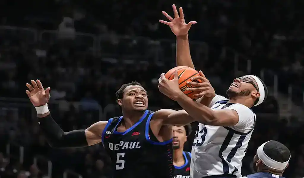Butler Bulldogs player attempts a basket against DePaul Blue Demons defense during a January 20, 2024, college basketball game.