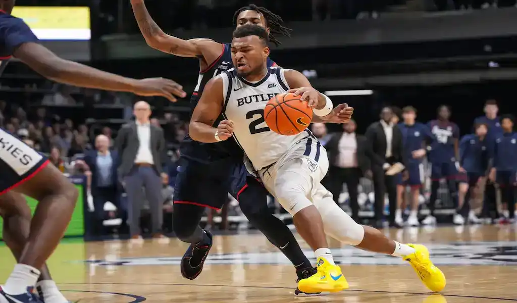 Butler Bulldogs player dribbles against Seton Hall Pirates defense during a January 13, 2024, college basketball game.