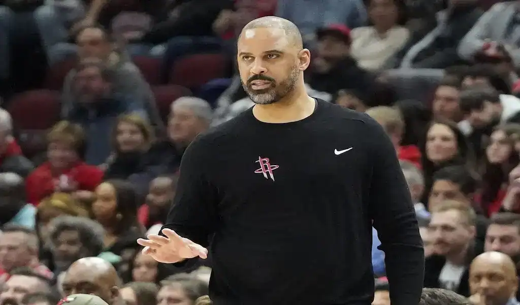 Houston Rockets coach giving instructions courtside during an NBA game against the Boston Celtics on January 13, 2024.