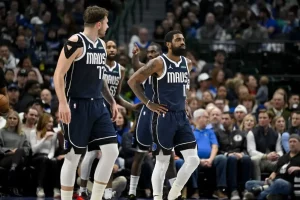 Dallas players regroup on the court during a break in play.