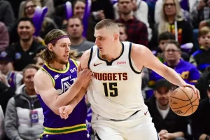 Denver Nuggets center Nikola Jokić backs down a defender.
