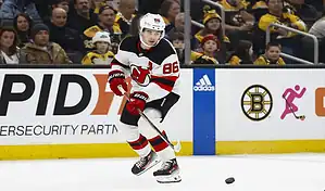 New Jersey Devils player controls the puck during an NHL matchup against the Chicago Blackhawks.