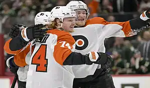 Philadelphia Flyers players celebrate a goal against the Colorado Avalanche during an NHL game.