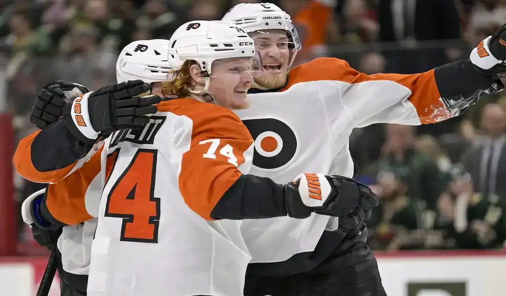 Philadelphia Flyers players celebrate a goal against the Colorado Avalanche during an NHL game.