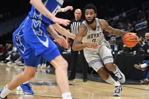 A Georgetown Hoyas player drives past a defender.