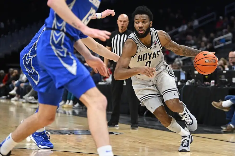 NCAAB 5 A Georgetown Hoyas player drives past a defender.