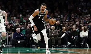 San Antonio Spurs player drives the ball up the court against the Charlotte Hornets during an NBA game on January 19, 2024.