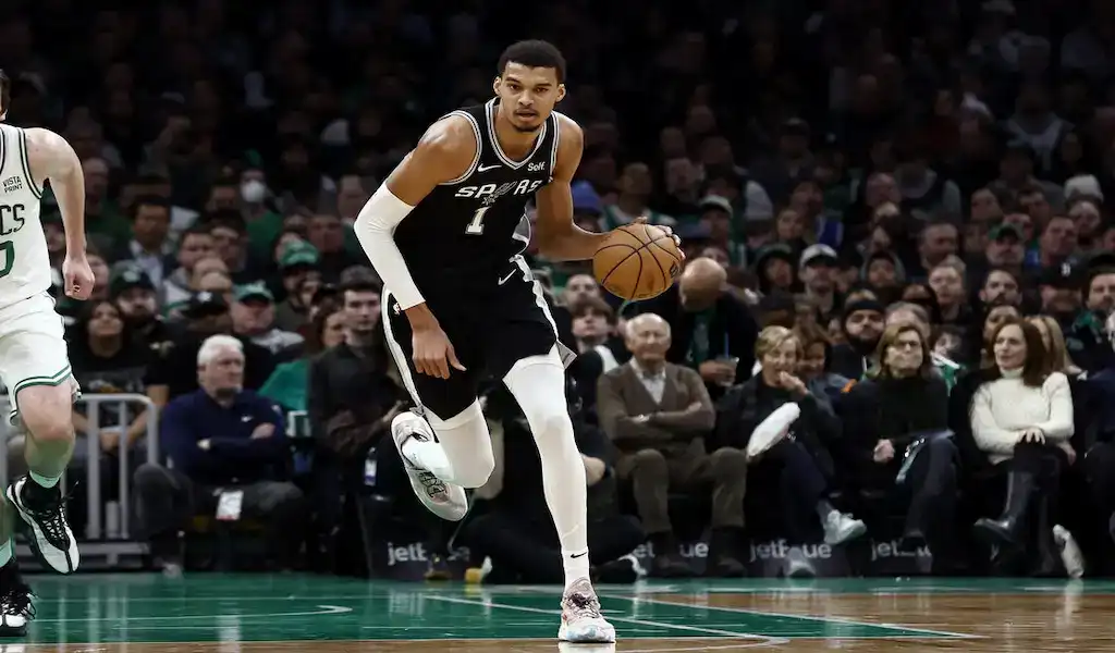 San Antonio Spurs player drives the ball up the court against the Charlotte Hornets during an NBA game on January 19, 2024.