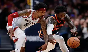New York Knicks player battles Denver Nuggets defender for loose ball during NBA game.