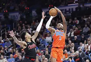 Oklahoma City Thunder player shoots over Trail Blazers defender.