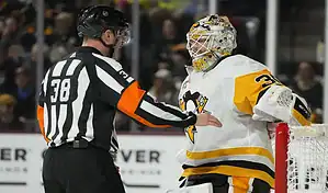 Pittsburgh Penguins goalie talks with referee during a game against the Florida Panthers on January 26, 2024.
