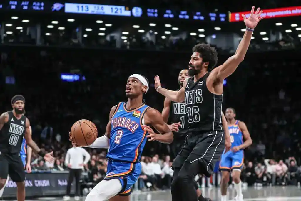 Thunder’s number 2 drives to the basket as a Nets defender attempts to block the play.