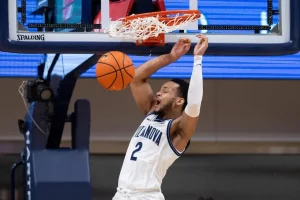 A Villanova basketball player throws down a powerful two-handed dunk.