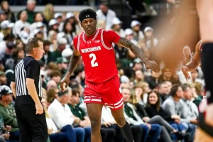 A Wisconsin basketball player wearing jersey number 2 walks across the court.