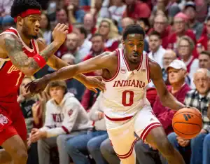 Indiana Hoosiers player drives past Illinois defender during January 27, 2024 college basketball game
