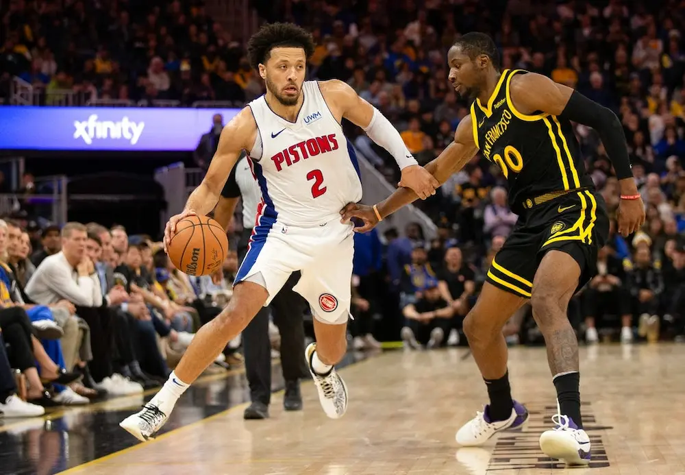 pistons nba player evading rival player