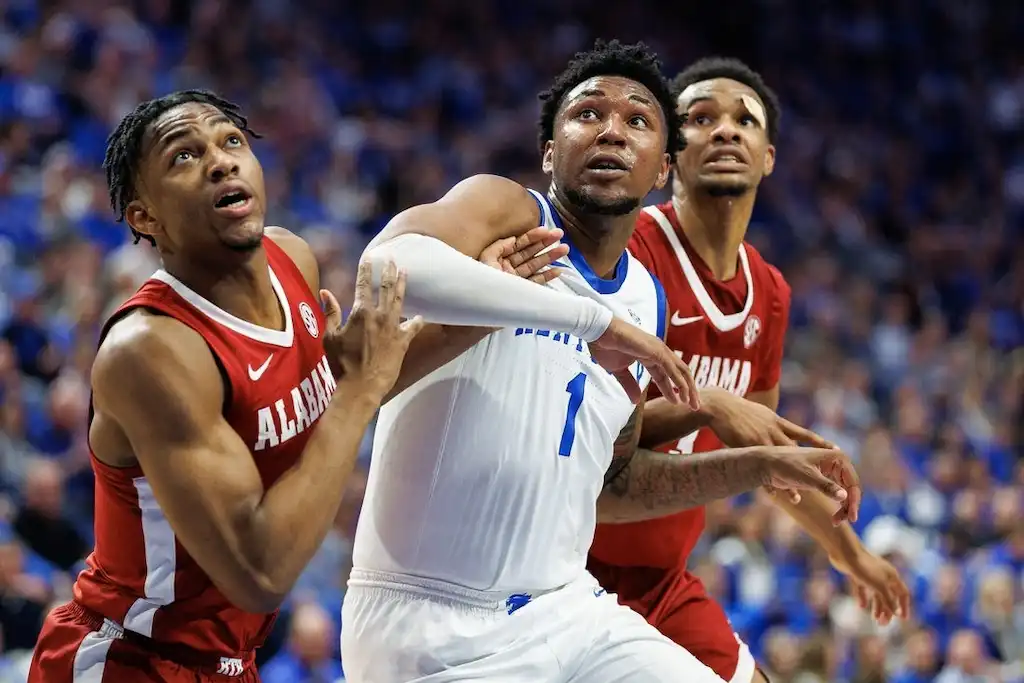 Two Alabama defenders battle for position under the basket.