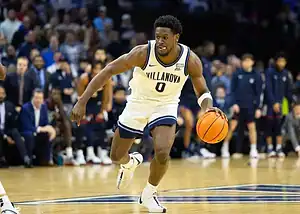 Villanova player wearing number 0 dribbles the ball down the court during a game.
