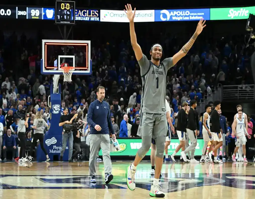 NCAAB 1 Butler Bulldogs player celebrates victory on court as Creighton Bluejays players walk off after the game