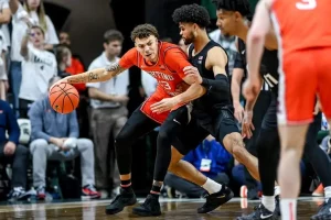 Illinois player attempts to drive past a defender in during a tightly contested game.