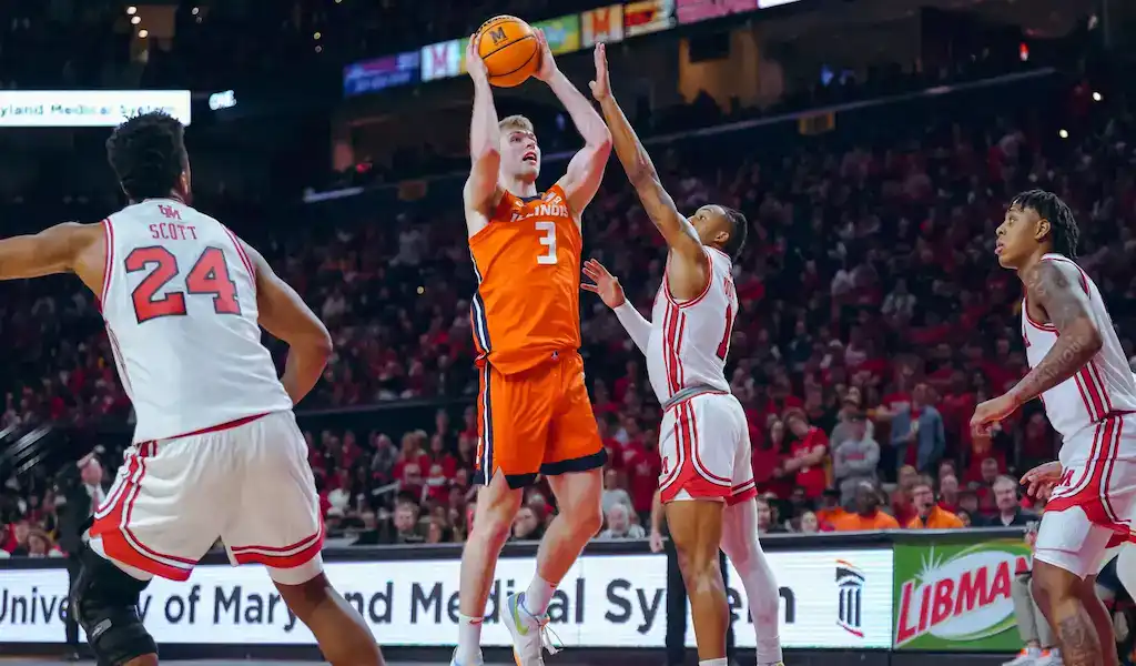 Illinois Fighting Illini player shoots over Maryland Terrapins defenders during NCAA basketball game on February 17, 2024.