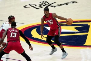A Miami Heat player dribbles the ball near midcourt.