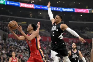 A New Orleans Pelicans player drives to the basket for a layup.