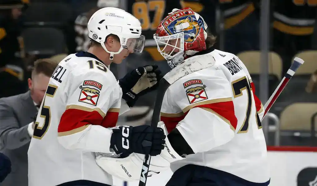 Florida Panthers players celebrating together on the ice during an NHL game.