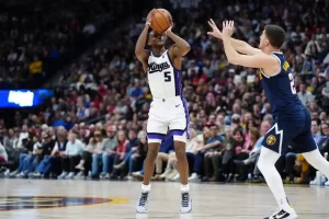 A Sacramento basketball player takes a jump shot.