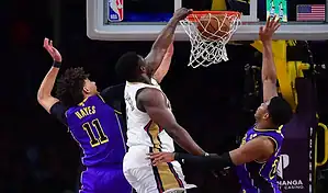 New Orleans Pelicans player Zion Williamson scores a basket while being defended by the Portland Trail Blazers during a February 10, 2024, NBA game.