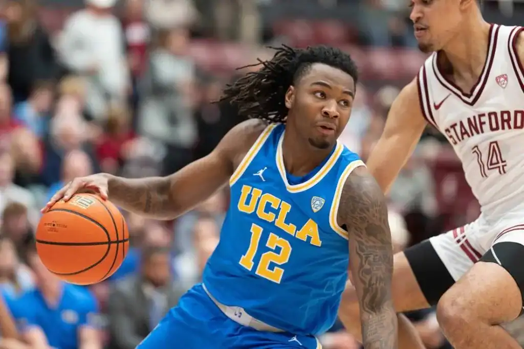 UCLA Bruins basketball player #12 dribbling the ball during a game.