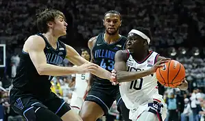 Villanova Wildcats defend against a Georgetown Hoyas player driving to the basket during their February 27, 2024 matchup.