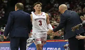 Wisconsin Badgers player heads to the bench during a college basketball game against the Ohio State Buckeyes on February 13, 2024.