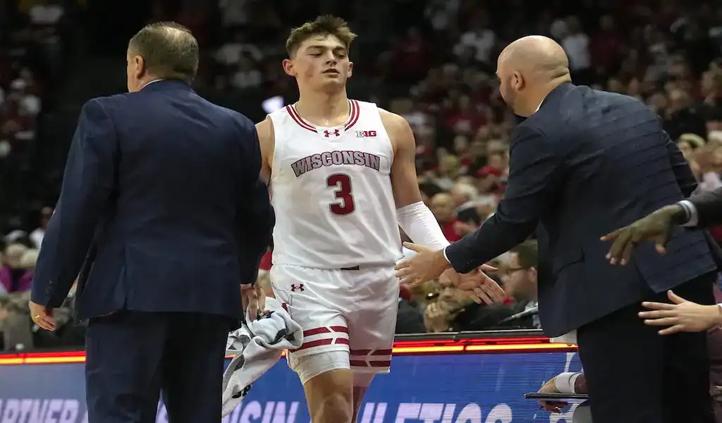 Wisconsin Badgers player heads to the bench during a college basketball game against the Ohio State Buckeyes on February 13, 2024.
