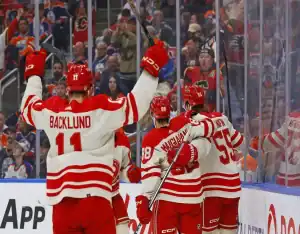 Calgary Flames players celebrate a goal during their February 27, 2024 game against the Los Angeles Kings