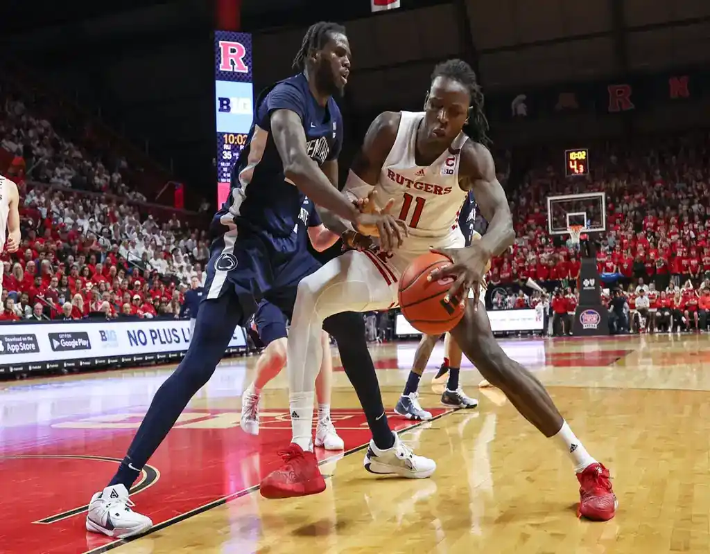 Rutgers and Penn State players battle for possession during their February 3, 2024 NCAA basketball matchup