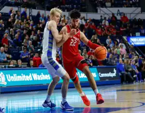 New Mexico Lobos player drives past Wyoming Cowboys defender during the February 6, 2024 matchup