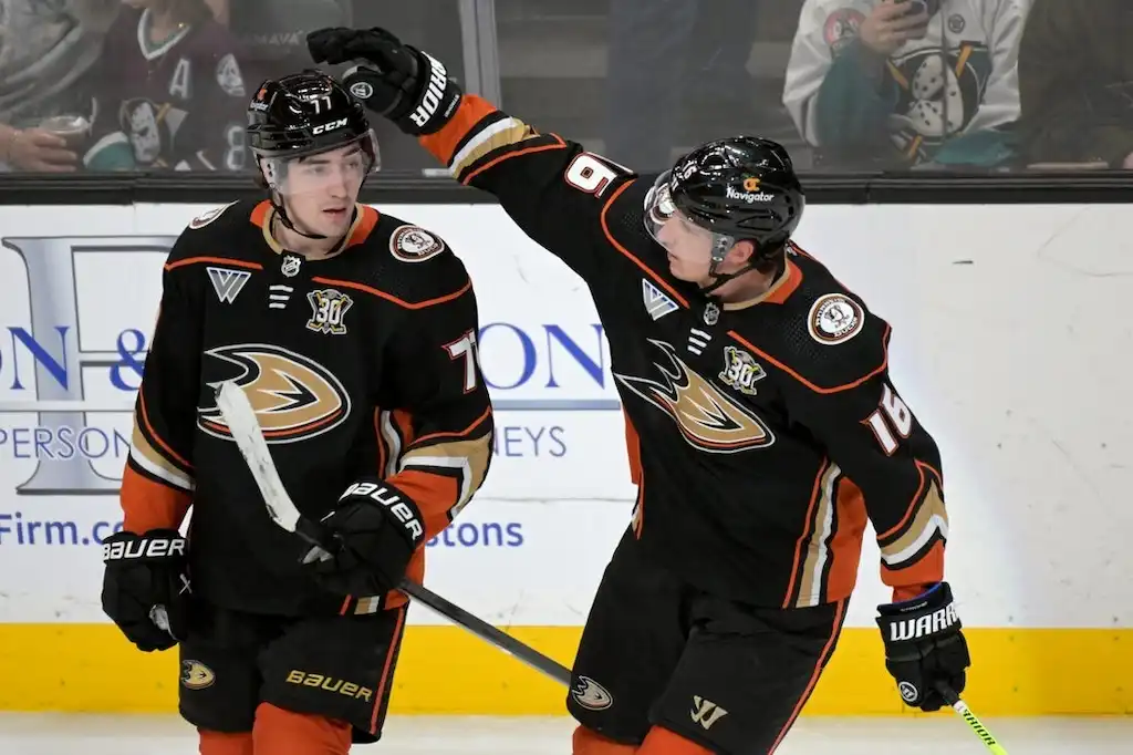 NHL 3 Two Anaheim Ducks hockey players celebrate on the ice.