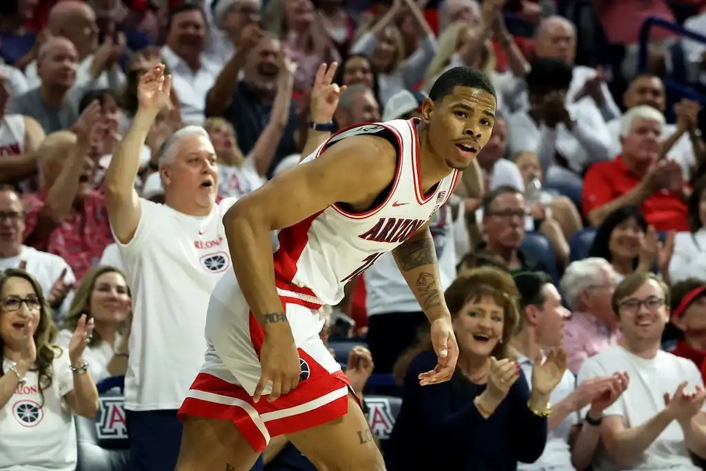 Arizona Wildcats basketball player celebrates on the court.