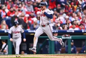 An Atlanta Braves player sprints toward home plate with determination.