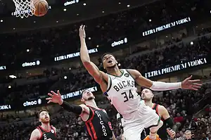 Giannis Antetokounmpo #34 of the Milwaukee Bucks shoots over Chicago Bulls defenders.
