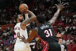 Miami Heat's Gabe Vincent (31) defends against Denver Nuggets' Jamal Murray (24) during a basketball game.