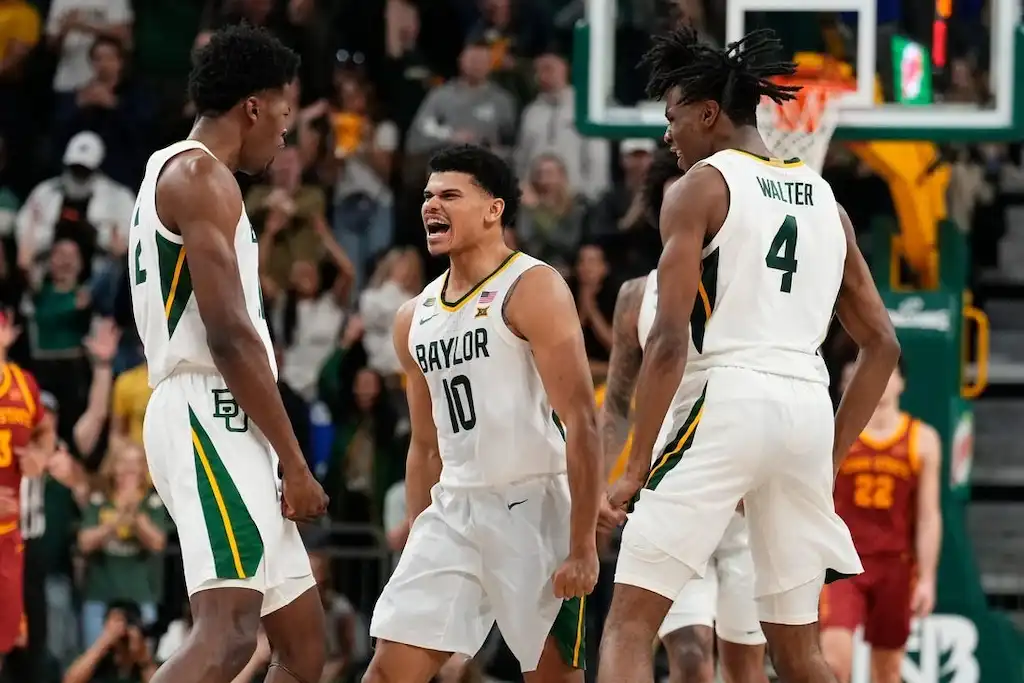NCAAB 9 Baylor basketball players celebrate on the court.