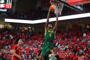 Baylor Bears player number 11 dunks the ball during a college basketball game against Texas Tech.