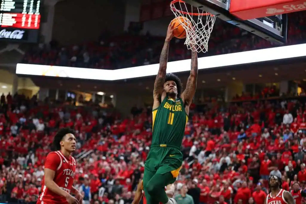 NCAAB 4 Baylor Bears player number 11 dunks the ball during a college basketball game against Texas Tech.