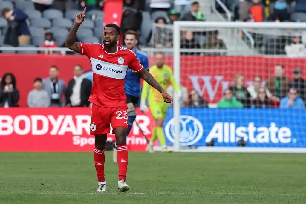 A Chicago Fire FC player raises his hand during a match.